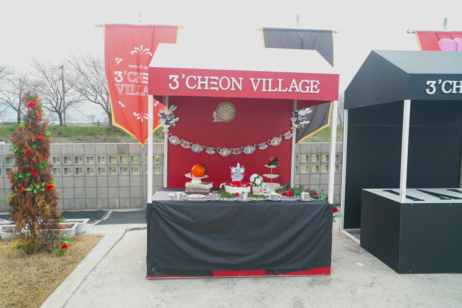 Poinsettias and fluttering flags adding pops of red across the whimsical garden cafe
