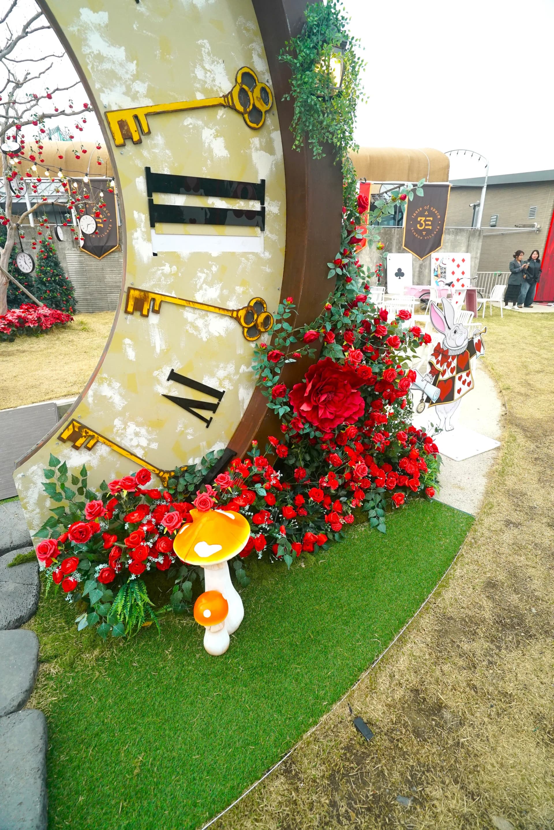 Mushroom sculptures and rose vine details beneath the giant clock in the garden cafe