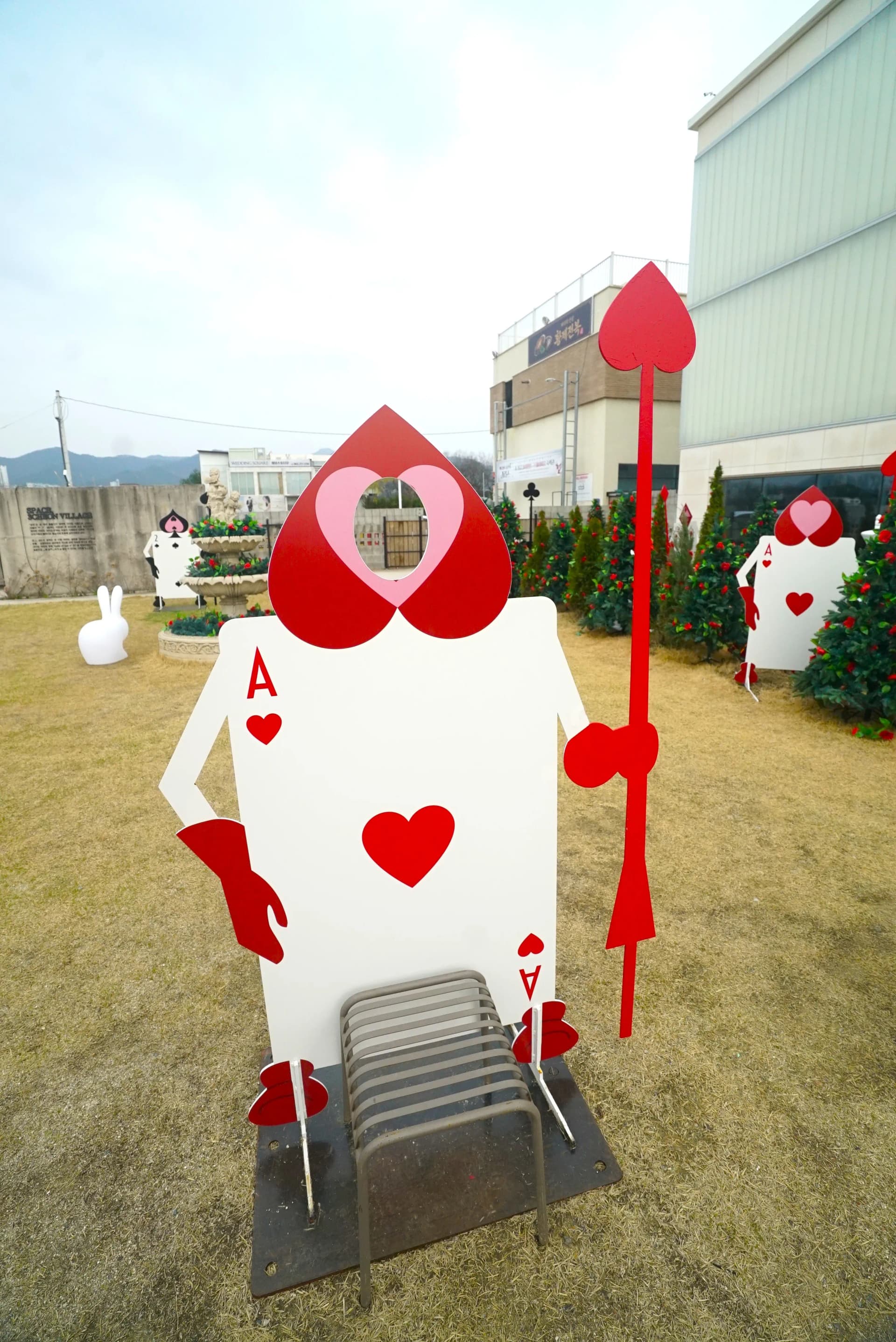 Ace of Hearts card soldier with face cutout for photo ops at this whimsical themed cafe