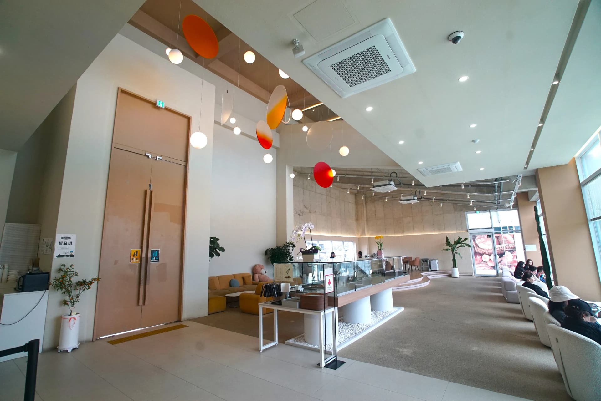 Exposed concrete walls with warm ambient lighting inside the instagrammable cafe interior