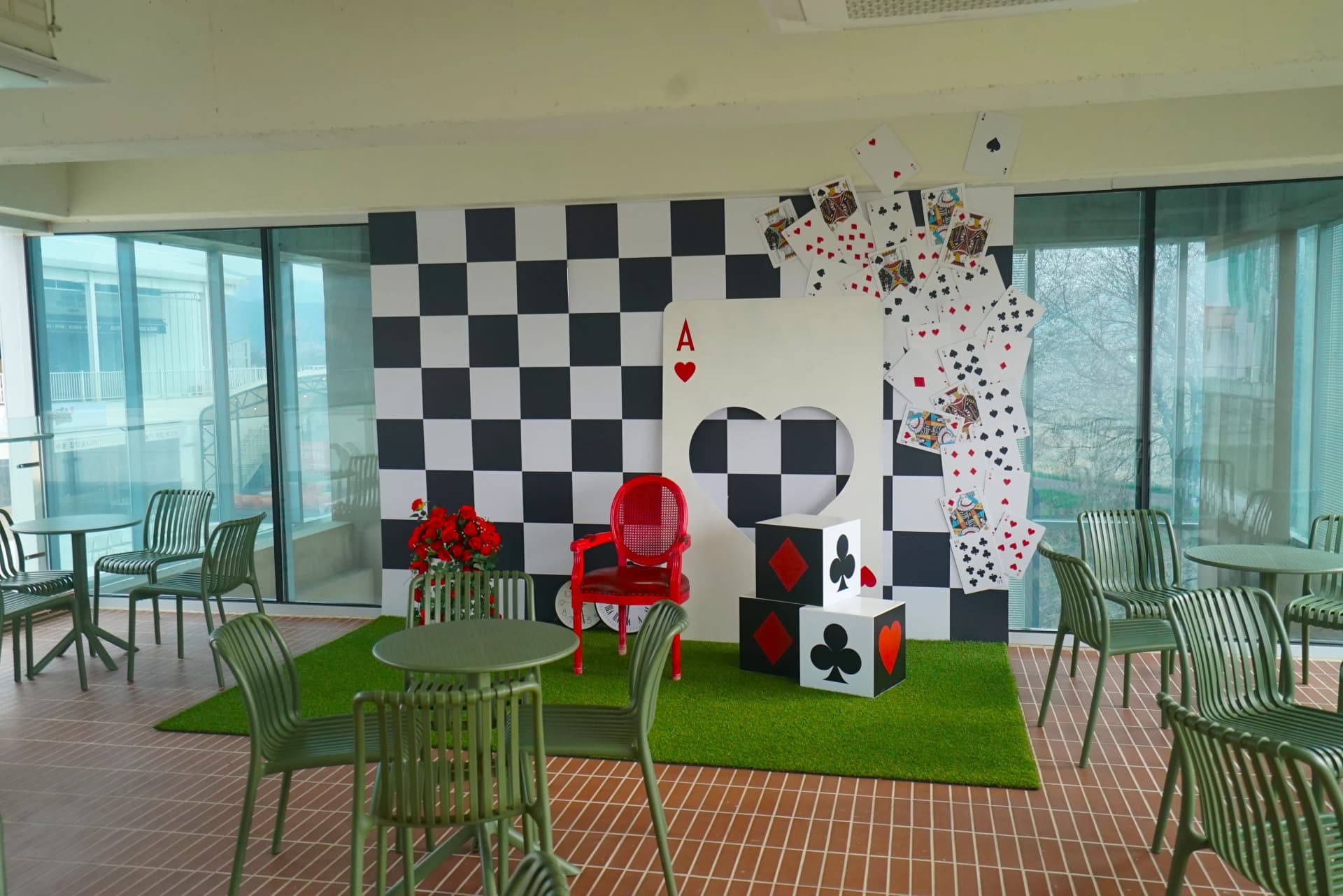 Close-up of red chair photo spot on the first floor terrace overlooking the garden
