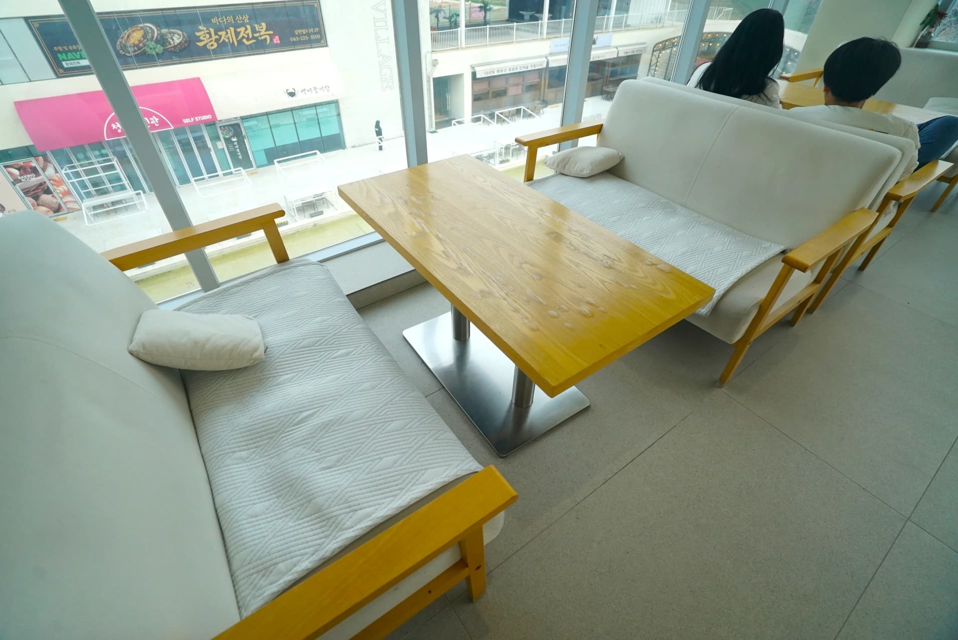 Face-to-face sofa seating with thick cushions and warm lighting on the upper level