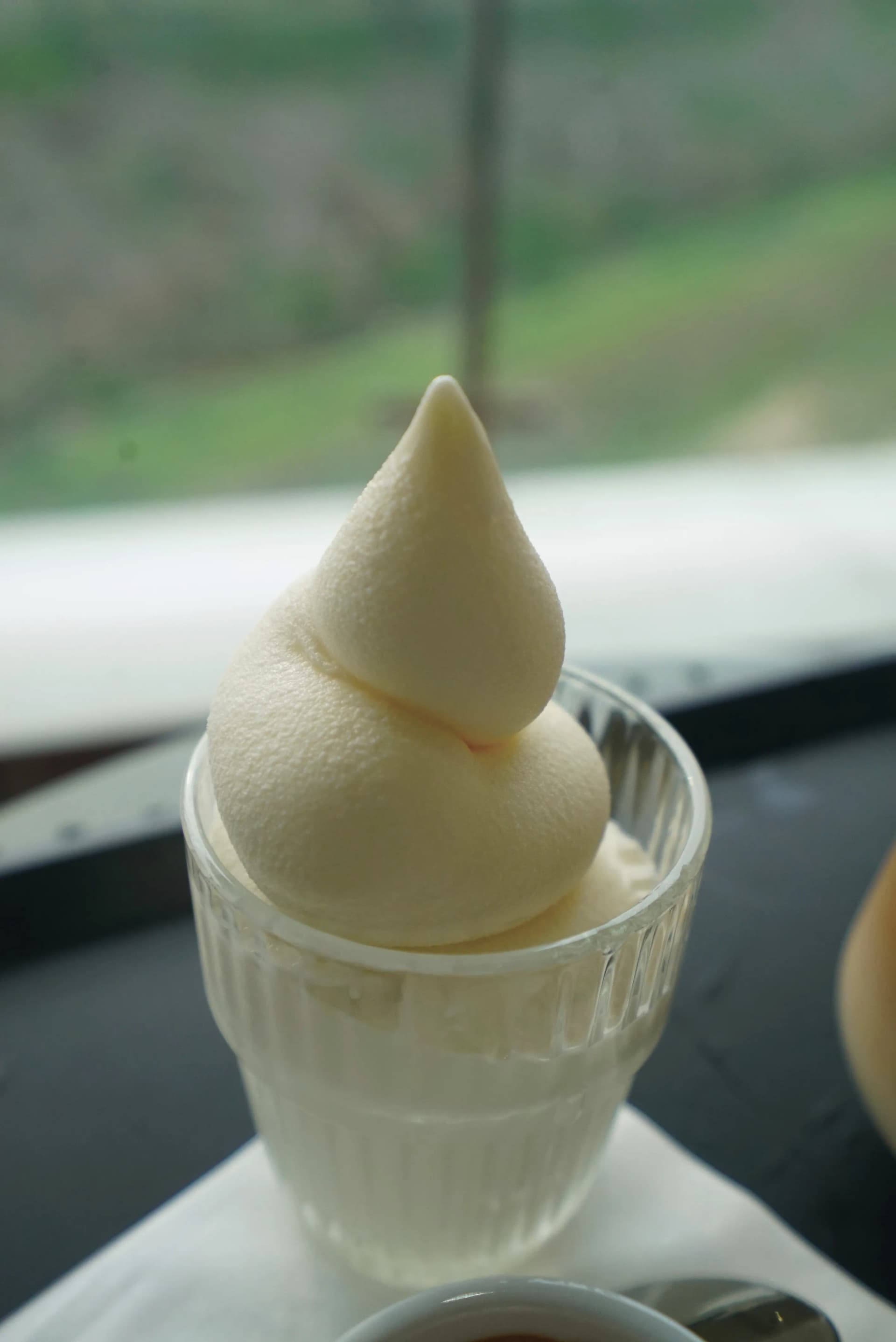 Close-up of affogato with a tall swirl of organic soft serve ice cream in a glass