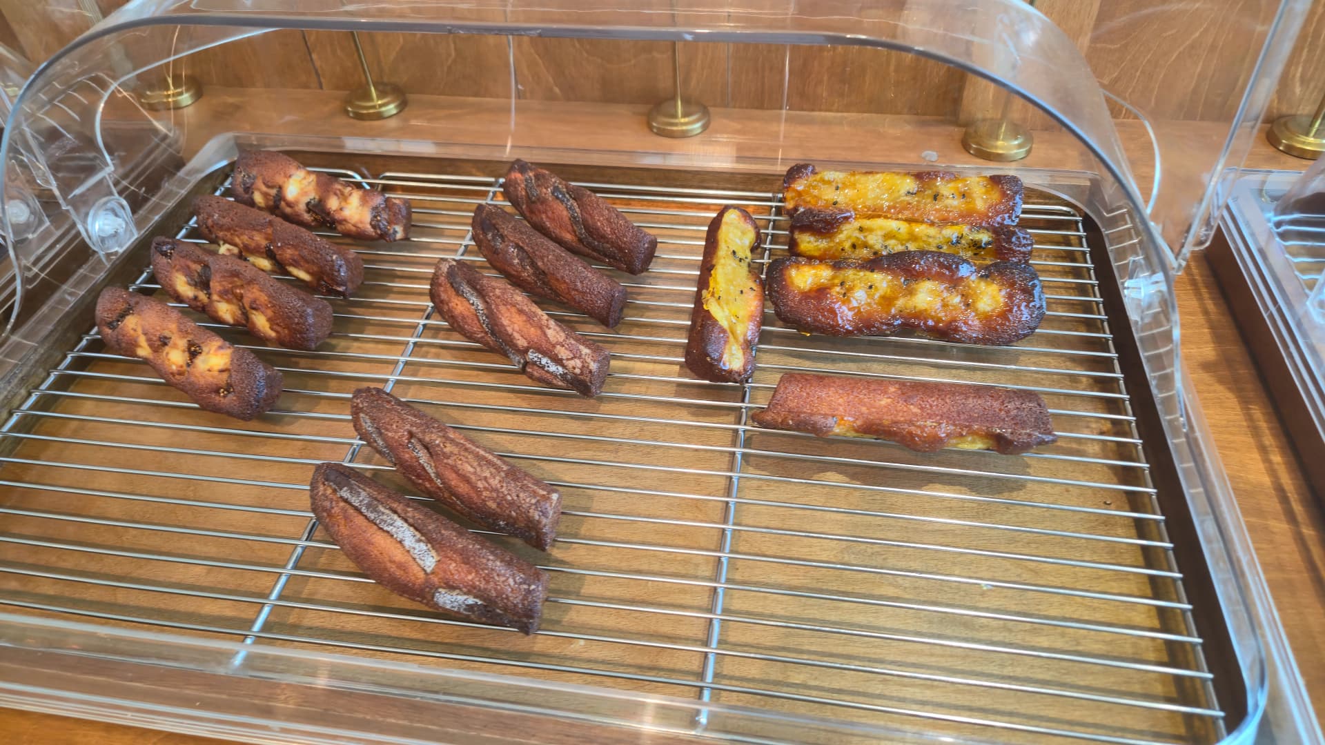 Tray of assorted financiers in plain, sweet potato and raspberry flavours at the artisan bakery