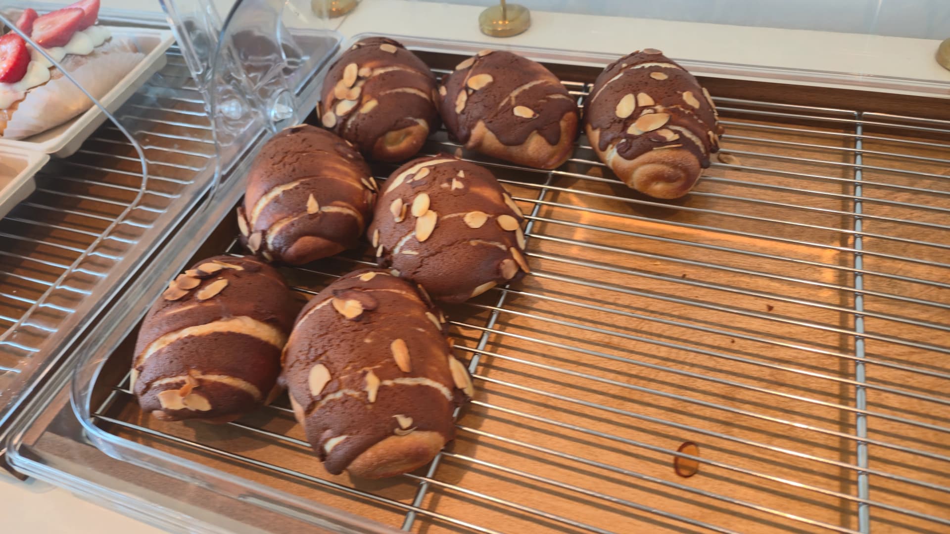 Choc almond salt bread with sliced almonds pressed into dark chocolate dough at the bakery
