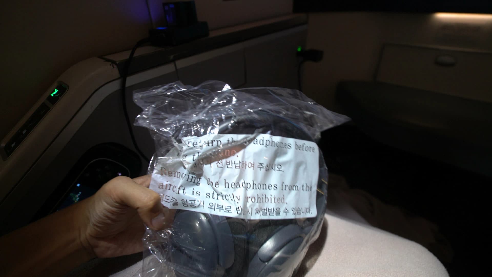 Sealed headset in plastic wrapping placed on Korean Air 747-8i Prestige Class seat