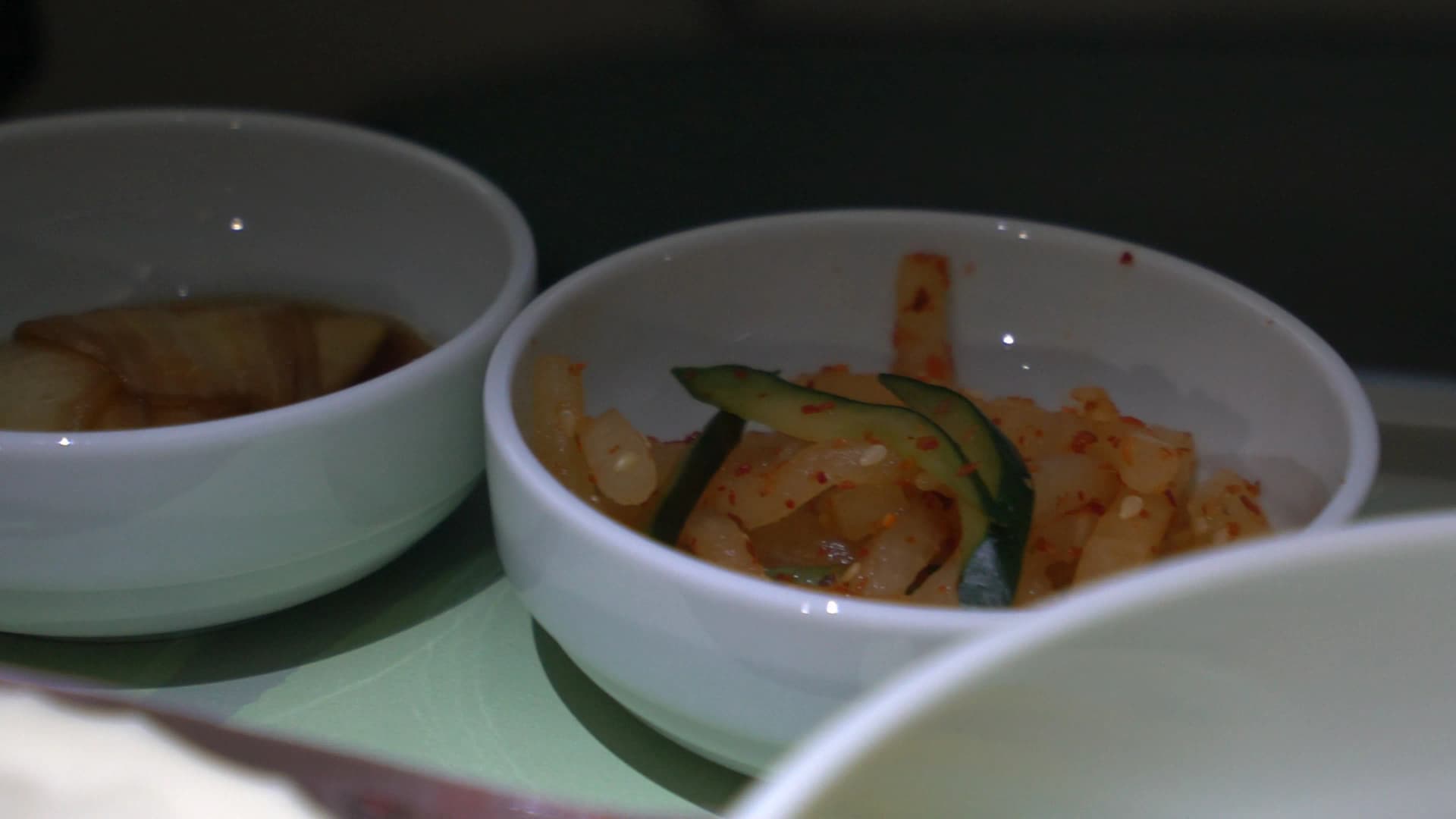 Spicy radish salad musaengchae served as bibimbap side dish on Korean Air business class tray