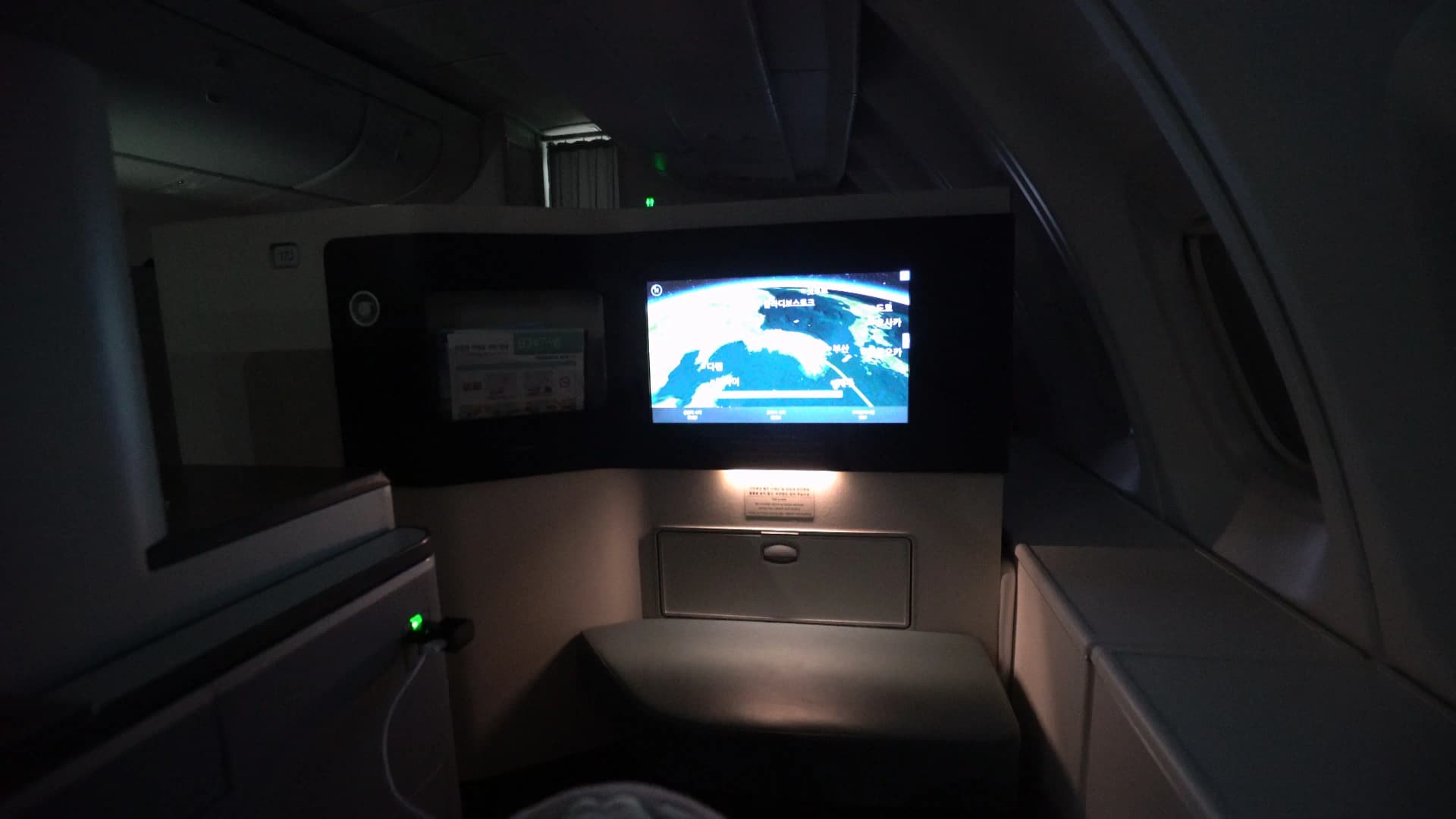 Darkened Korean Air 747-8i Prestige Class cabin after meal service with lie-flat seat prepared for sleep