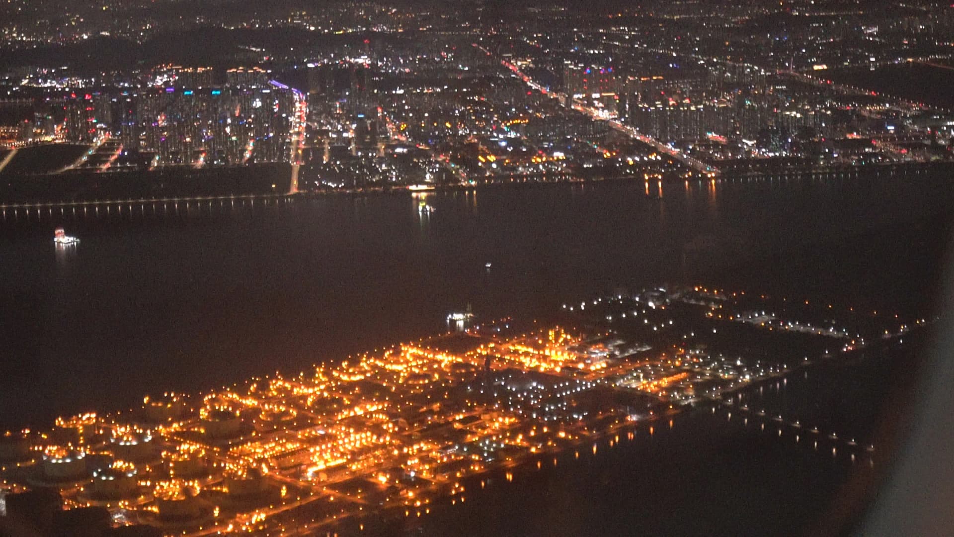 Incheon Airport southern approach night view with orange harbour lights and city skyline across the water
